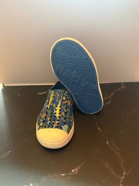 Native Shoes Kids Slip-On Sneakers in Blue with Yellow Dino Print